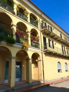 a yellow building with balconies and flowers on it at ANTICA FILANDA Lattes in Cuneo