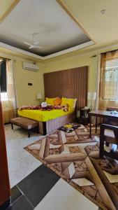 a bedroom with a yellow bed and a rug at Dodoma Siesta Inn in Dodoma