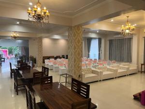 a banquet hall with tables and chairs in a room at HOTEL SHIV PALACE in Jaipur