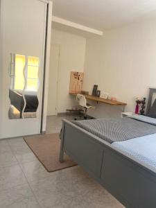 1 dormitorio con cama, escritorio y ventana en Bas de Villa détente en Carros