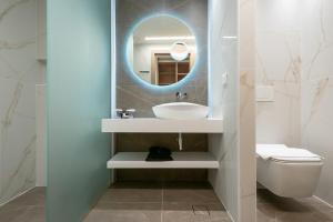 a bathroom with a sink and a mirror at GRAND PATELLI in Myrina