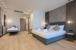 a hotel room with two beds in a room at GRAND PATELLI in Myrina