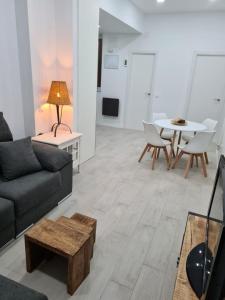 a living room with a couch and a table at Apartamento pet-friendly en Atocha by beBalmy in Madrid