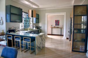 a kitchen with a large island in the middle at Villa Nducha in Dar es Salaam