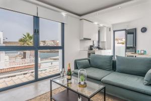 a living room with a couch and a glass table at TORREÓN FRENTE AL MAR in Adeje
