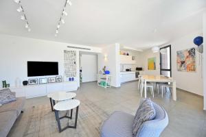 a living room with a couch and a table at Granite 2BR by HolyGuest in Tel Aviv