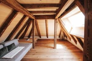 a attic room with a bed and a window at Ansitz Layshof Apartment Turm in Merano