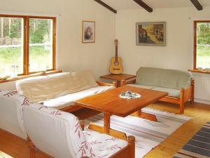 a living room with a couch and a table at 6 person holiday home in Osby in Osby