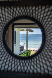 a view of the ocean through a hole in a grate at Solwota Sands in Port Vila