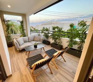 a living room with a couch and a table on a balcony at Top Artistic Luxury Apartment in Limassol