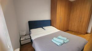 a bedroom with a bed with two towels on it at Queen Apartament Centrum z garażem in Mińsk Mazowiecki
