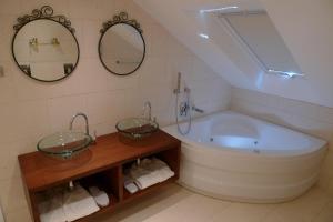 a bathroom with a large tub and two mirrors at San Teodoro Boutique Hotel in Korčula +69 photos