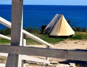 a tent sitting on top of a field next to the ocean at Ecoclub in Varna City