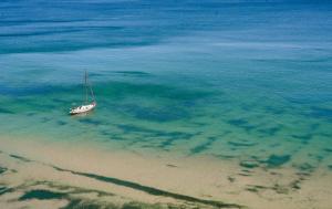 a boat sitting in the water on the beach at Ecoclub in Varna City