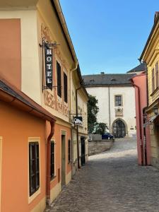 an empty street in a town with buildings at PENZION HRNČÍŘ in Kutná Hora