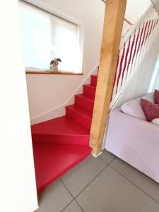 a dog looking out the window from the stairs of a house at Prestwick House - Sleeps 10+ - Main House & 3 Separate Oak Framed Barn Studios - Rural in Chiddingfold