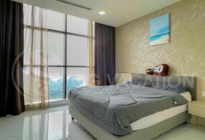 a bedroom with a bed and a large window at Lovely 3-bedrooms with Karaoke Genting Penthouse in Genting Highlands