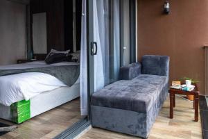 a bedroom with a bed and a chair and a table at Urban oasis in kingsland city in Lusaka