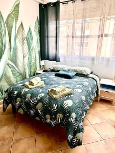 a bedroom with a bed with a blue and white blanket at Perle de Thau in Balaruc-les-Bains +3 photos