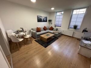 a living room with a couch and a table at FeWo Wanderlust #Innenstadt#Außenbereich#ruhige Lage von Harztraveler in Wernigerode