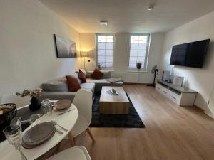 a living room with a couch and a table at FeWo Wanderlust #Innenstadt#Außenbereich#ruhige Lage von Harztraveler in Wernigerode +16 photos