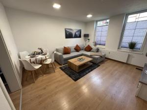 a living room with a couch and a table at FeWo Wanderlust #Innenstadt#Außenbereich#ruhige Lage von Harztraveler in Wernigerode