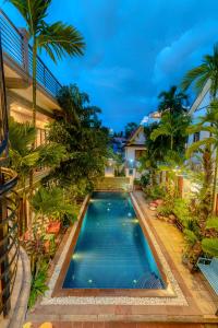 an image of a swimming pool in front of a house at Asanak D'Angkor Boutique Hotel in Siem Reap