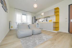 a living room with a couch and a kitchen at MILAN MCHOME in Trezzano sul Naviglio