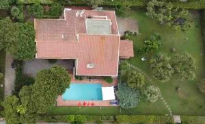 an aerial view of a house with a swimming pool at Villa Marisa in Fregene