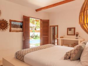 a bedroom with a bed and a large window at Villa Onu Mentawai - Private Rooms in Katiet