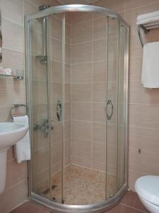 a shower with a glass door in a bathroom at Hotel Süreyya in Istanbul +48 photos