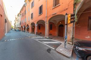 an empty street with orange buildings and a traffic light at HouSmart Tovaglie 9 int. 6 in Bologna