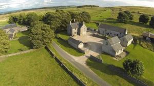 an aerial view of an old house in a field at The Grange in Buxton