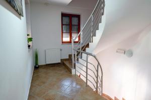 a staircase in a house with white walls and a window at Apartmaji Pr' Kopavank in Rateče