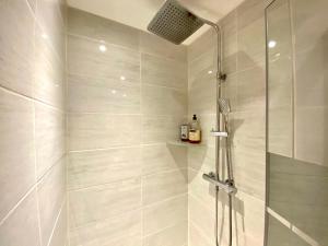 a bathroom with a shower with a glass door at Les Capitole I - Studio avec climatisation in Toulouse