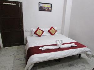 a hotel room with a bed with a towel on it at Ashish Guest House, Goverdhan Vilas in Udaipur