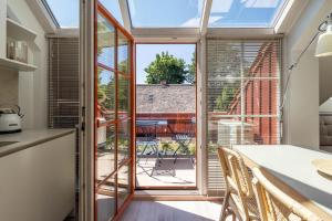 a kitchen with a large glass door leading to a patio at Nauji apartamentai! Pamario 14 in Nida