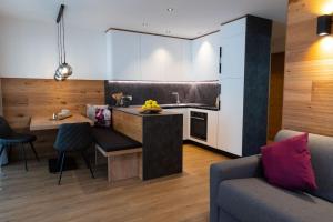 a kitchen with a couch and a table in a room at Appartement Sonnlicht in Falzes