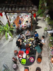 a group of people sitting around a table with food at Tùng Dương Homestay in Cao Bằng