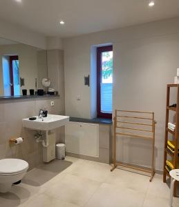 a bathroom with a sink and a toilet at Himmel & Hölle Ferienhäuser in Quedlinburg +20 photos