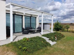 a pavilion with a table and chairs on a patio at Apartmán Polička in Polička