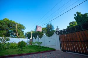 una cerca blanca con una puerta y un aro de baloncesto en JAMUNA VILLA, en Jaffna