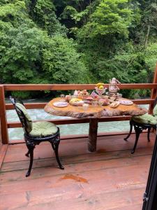 a table with food on it on a deck at Hoşdere Suit in Çamlıhemşin