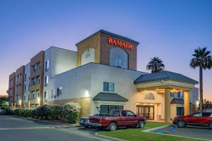 a red truck parked in front of a hotel at Ramada by Wyndham Bakersfield in Bakersfield