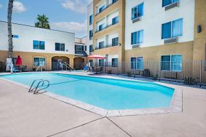 a swimming pool in front of a building at Ramada by Wyndham Bakersfield in Bakersfield +42 photos