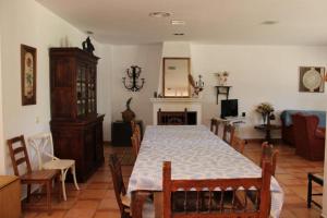 une salle à manger avec une table, des chaises et une cheminée dans l'établissement Complejo Cortijo Rural el Puntal, à Teba