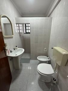 a white bathroom with a toilet and a sink at Charming 3-Bed Studio in Arrentela in Arrentela