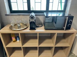 a table with a coffee maker and wine glasses on it at Charming 3-Bed Studio in Arrentela in Arrentela