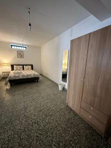 a bedroom with a bed and a large wooden cabinet at Charming 3-Bed Studio in Arrentela in Arrentela