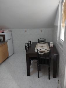 a kitchen with a table and chairs in a room at Apartman Šljivo in Konjic